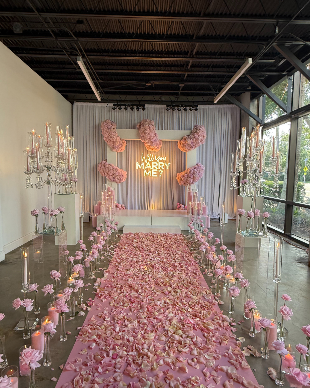 Luxury floral proposal stage installation with rose petals at Orlando event